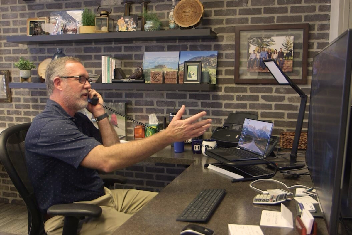 Brent Haverkamp, Founder and CEO of Haverkamp Group talks on the phone with Hertz Farm Managers discussing various farmland properties across the Midwest.
