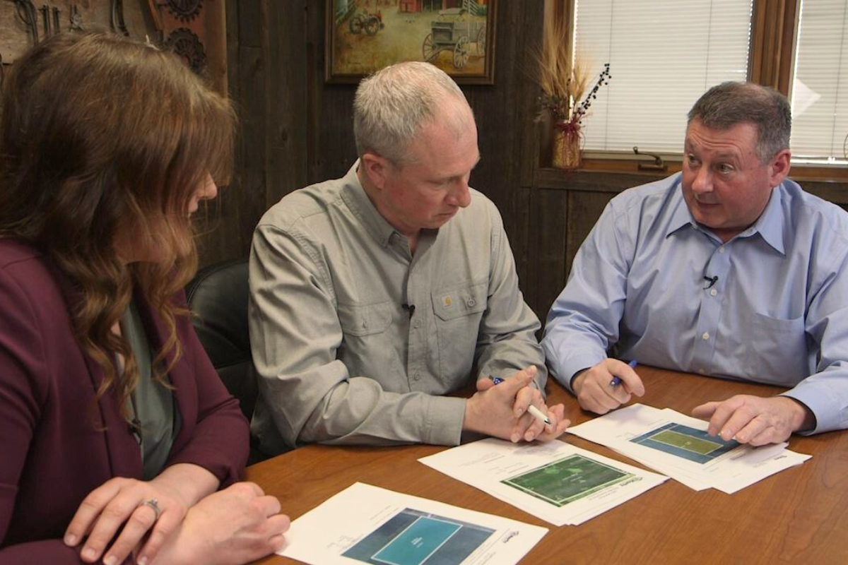 Hertz Farm Managers Carrie Seidel, Tom Carlson, and Scott Henrichsen discussing various farmland operations and stewardship opportunities.