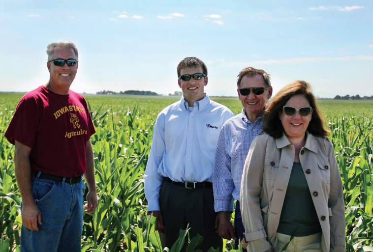 Kevin Gerlach, farm custom operator, Joel Waskow, Hertz manager, Bill Dunn and Joanne Kennedy discuss  the progress of their seed corn crop.