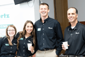 Farmland real estate team members at community auction, representing Hertz auction