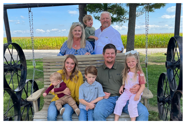 Terhune Family sitting on a bench on their farm in Illinois.