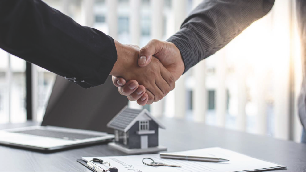 Shaking hands house and paperwork