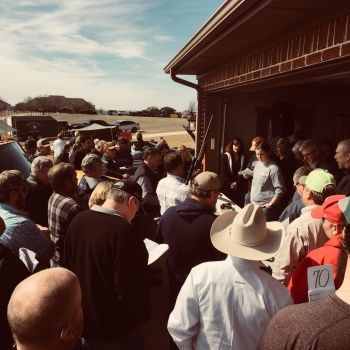 Group of people conducting live property auctions near Houston, TX